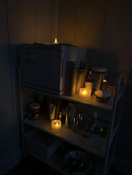 The product trolley beside the massage table.